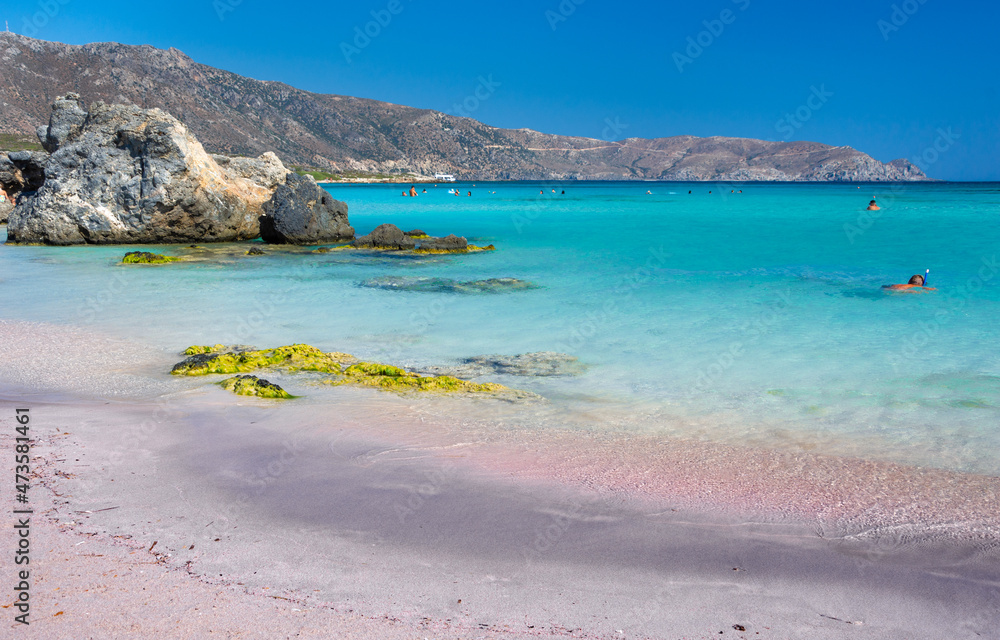 Tropical sandy beach with sandcastles and turquoise water, in Elafonisi, Crete, Greece