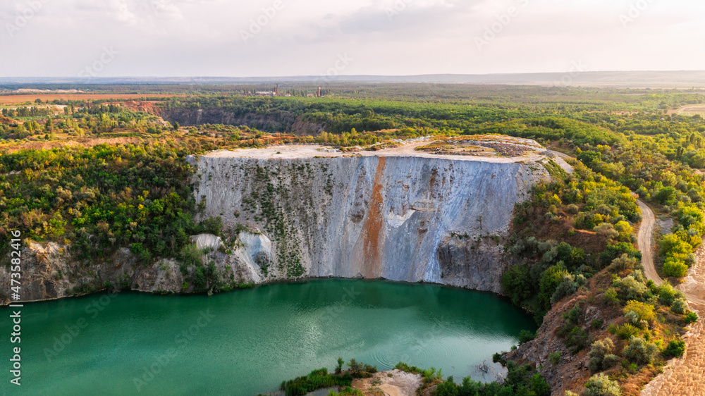 Radon quarry in Ukraine in the rays of the sun. Mining industry. Alexandrovka, Ukraine Radon quarry in Ukraine in the rays of the sun. Mining industry. Alexandrovka, Ukraine