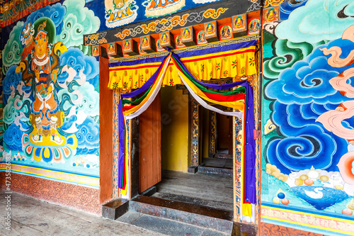 Colorful murals and entrance doors inside of the Punakha Dzong monastery in Punakha, Bhutan, Asia