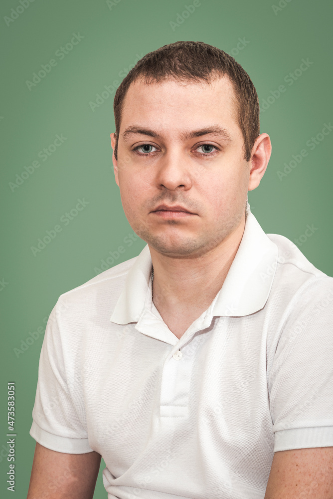 Portrait of a young man in a white polo shirt Portrait of a young man in a white polo shirt