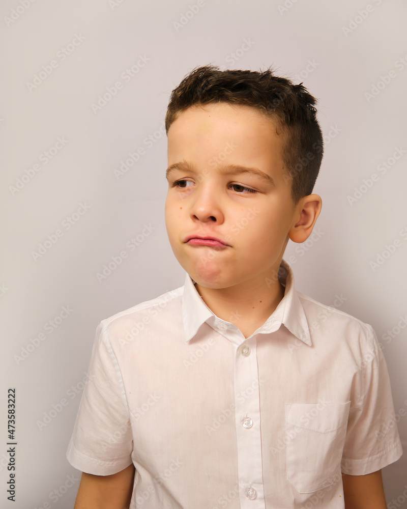 The boy shows an expression of discontent The boy shows an expression of discontent