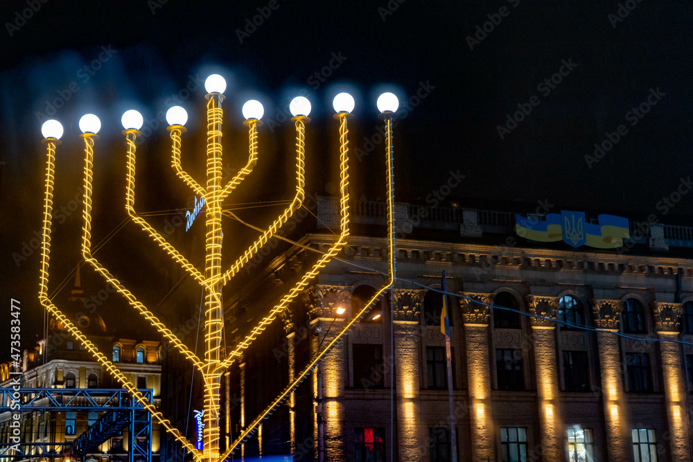 Jewish new year Hanukkah. Candles are installed on the square of the night city