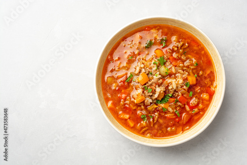 Stuffed pepper soup in bowl on concrete background