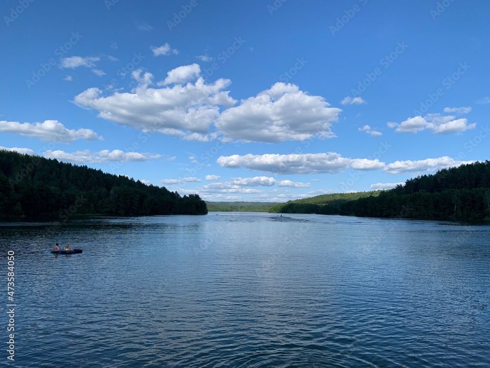the calm expanse of Lake Yulovskoe surrounded by forest and greenery in summer the calm expanse of Lake Yulovskoe surrounded by forest and greenery in summer