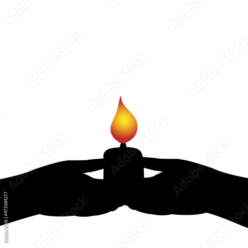 Silhouettes of hands holding burning candle.