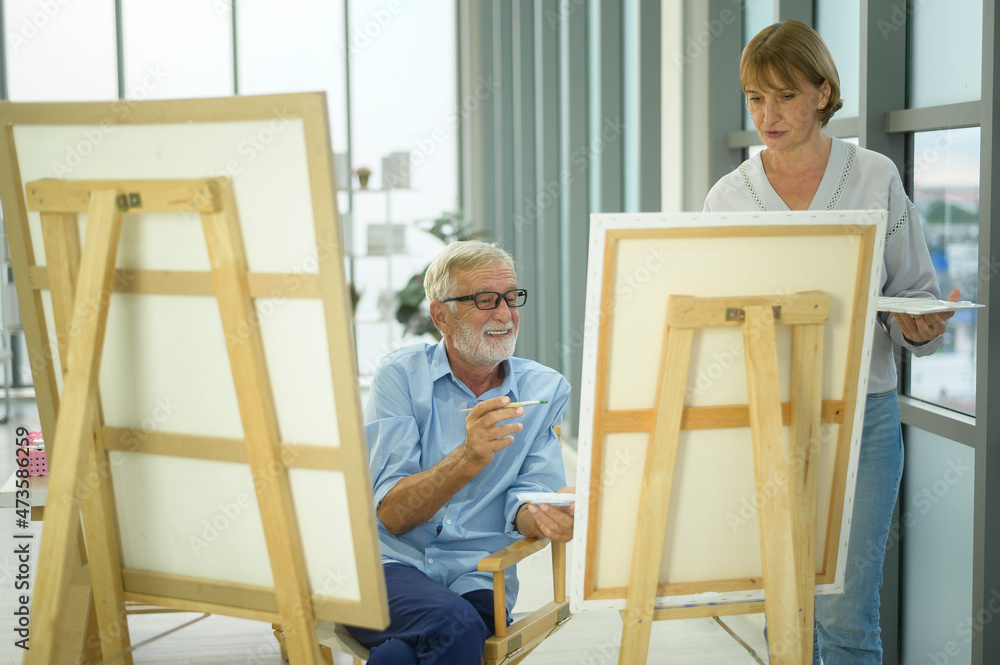 Senior caucasian couple painting and relaxing at home Senior caucasian couple painting and relaxing at home