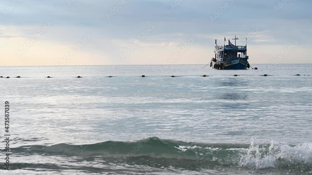 The aerial view of fishing boat in the turquoise sea water. Beautiful tropical island in southeast Asia with stunning nature. fisherman's boat. Picturesque scenery from above. The aerial view of fishing boat in the turquoise sea water. Beautiful tropical island in southeast Asia with stunning nature. fisherman's boat. Picturesque scenery from above.