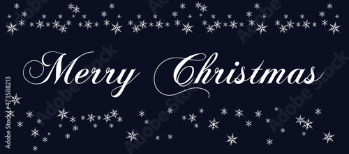 White lettering Merry Christmas with a lot of snowflakes on dark blue background. Christmas traditional greeting card 