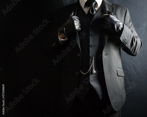 Portrait of Businessman in Dark Suit and Leather Gloves Standing Proudly. Vintage Style and Retro Fashion.