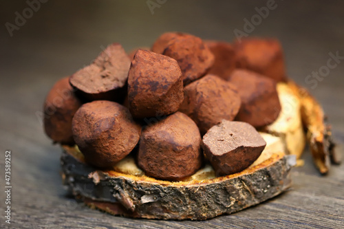 Selective focus. Macro. Chocolate truffles on a wooden surface.