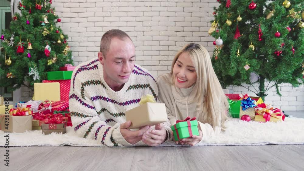 Couple happy talk together on christmas day, lifestyle of couple romance lover happy merry christmas holiday with tree before new year at home Couple happy talk together on christmas day, lifestyle of couple romance lover happy merry christmas holiday with tree before new year at home
