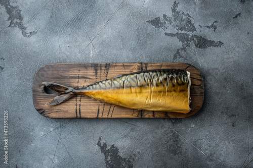 Whole smoked fish, on gray background, top view flat lay
