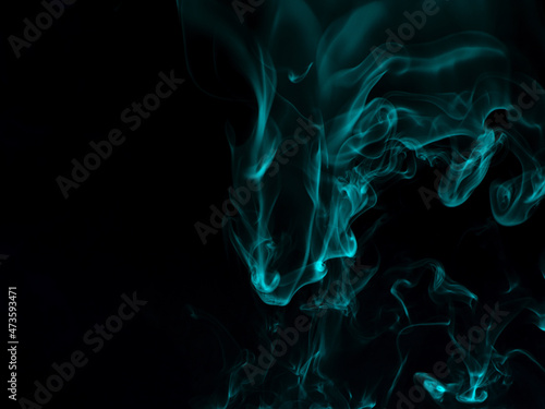 Chaotic mixing smoke creates abstract patterns on a black background