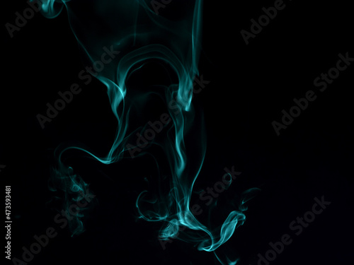 Chaotic mixing smoke creates abstract patterns on a black background