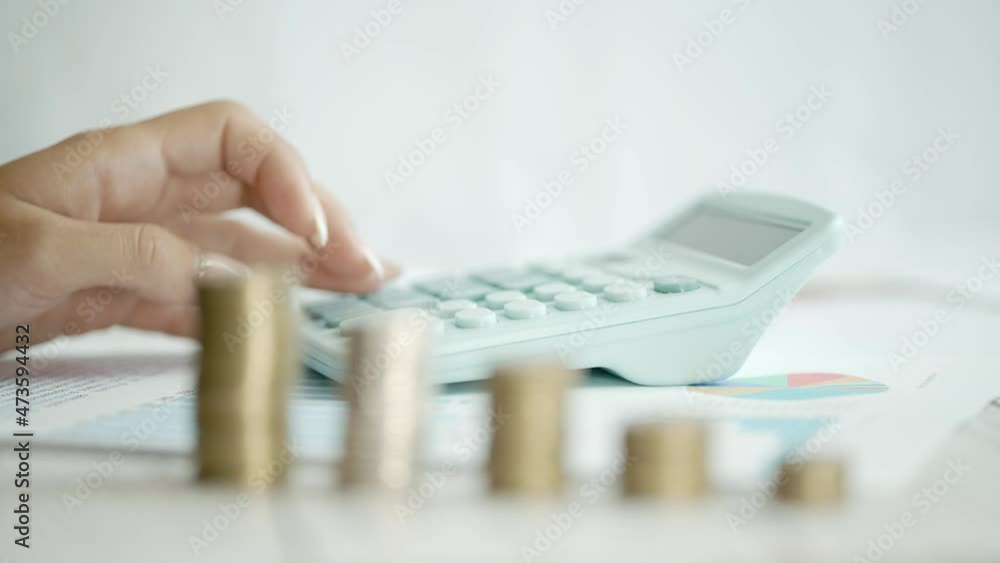 A woman is calculating her expenses for a month. Coins for taxes or payments. Concept of poverty savings money or counting budget and unemployment. Close up A woman is calculating her expenses for a month. Coins for taxes or payments. Concept of poverty savings money or counting budget and unemployment. Close up