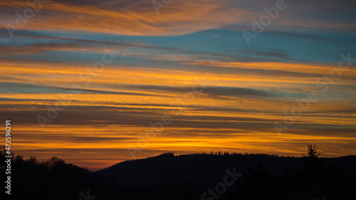 Afterglow over the hills of the Odenwald. A summer scene.