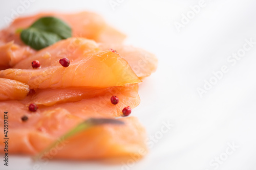 Slices of smoked salmon on white background