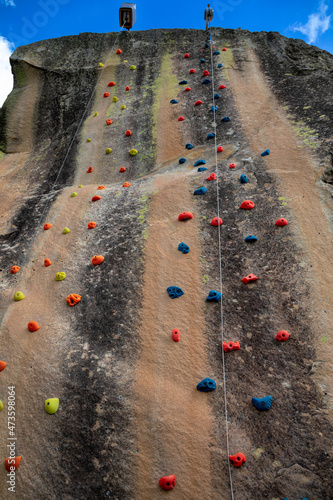 Vertical standstone rock with stripped patterns used for rock climbing  photo