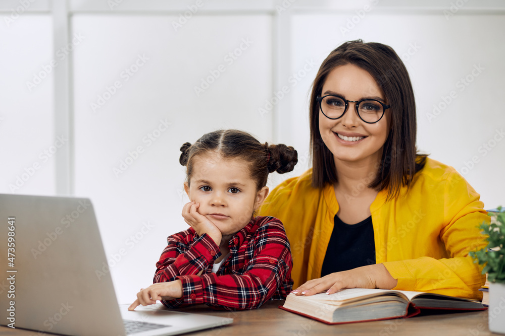 Mother and daughter having an online class together. Happy. Mother and daughter having an online class together. Happy.