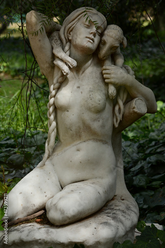 sculpture of a woman with a sheep or goat in her arms  in the botanical garden of buenos aires
