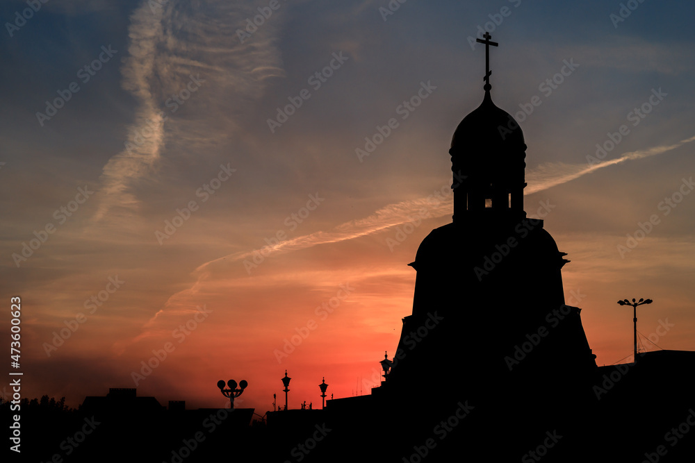 silhouette of the church on the background of the sunset sky in the summer