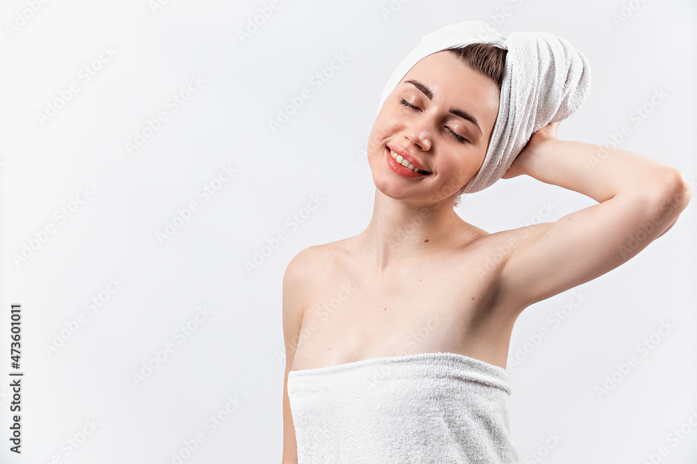 beautiful brunette girl in a white towel stands on a white background. isolated beautiful brunette girl in a white towel stands on a white background. isolated