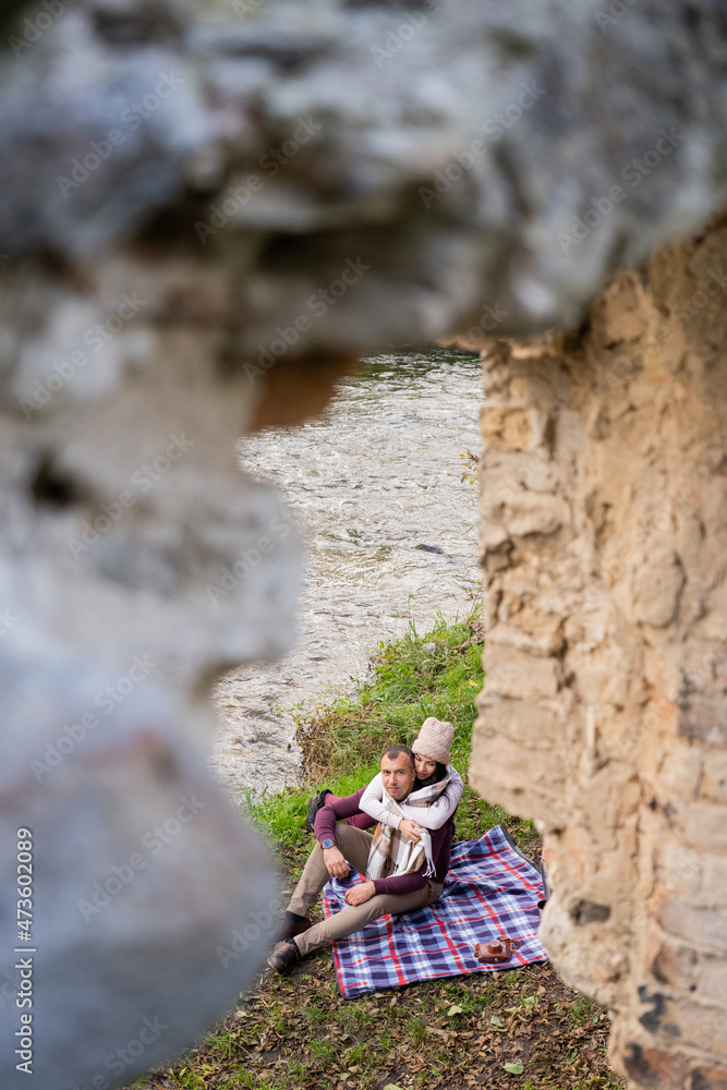 a guy and a girl are drinking tea near the river a guy and a girl are drinking tea near the river