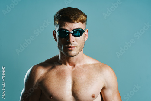 man in swimming goggles athlete swimmer blue background