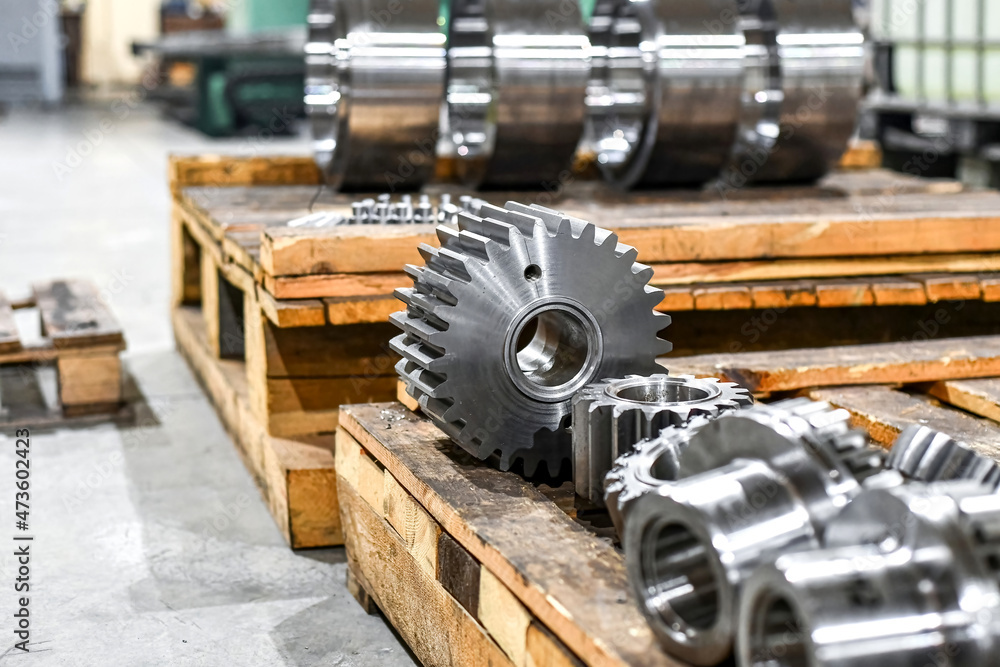Several cogwheels lie on the wooden planks. Several cogwheels lie on the wooden planks.