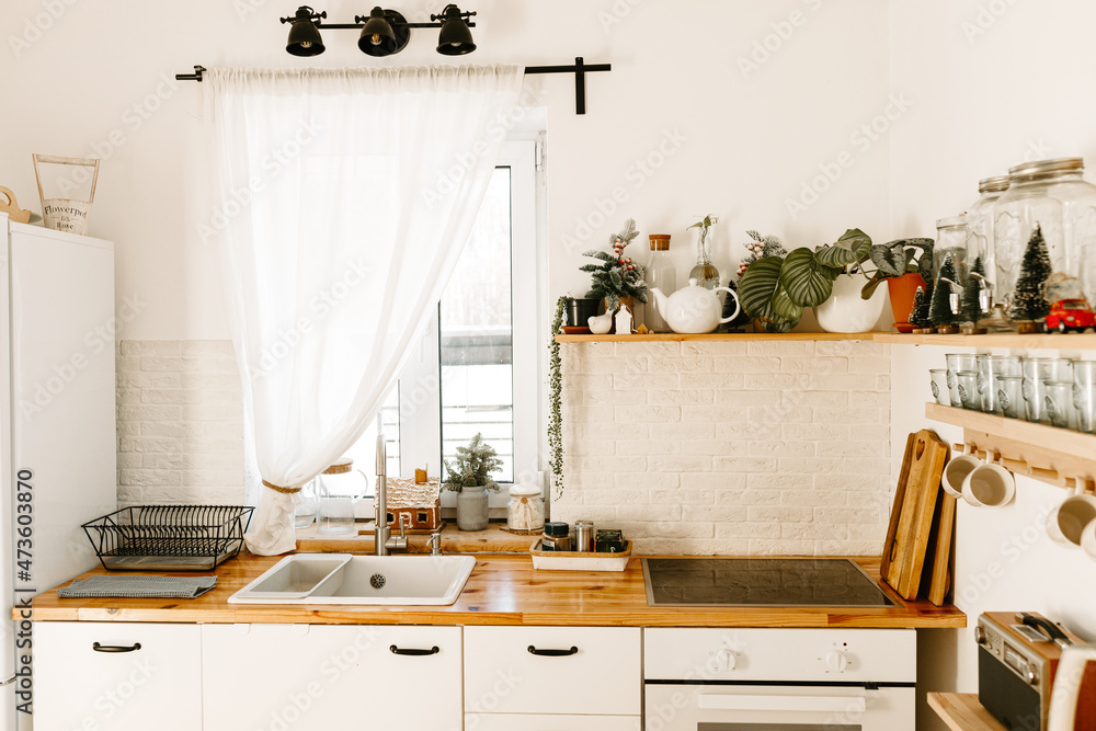 Christmas kitchen dining room. Beautiful Christmas decor of a classic home interior. Winter background Christmas kitchen dining room. Beautiful Christmas decor of a classic home interior. Winter background