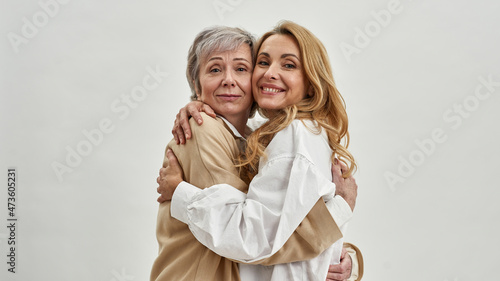 Portrait of smiling adult daughter and mature mom