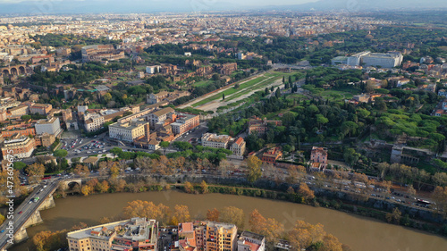 Aerial drone photo of iconic Circus Maximus a green space and remains of a stone - marble arena used for chariot races built next to Palatine hill and world famous Colosseum, historic Rome, Italy