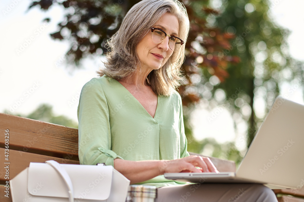 Woman working on laptop looking attentively at screen Woman working on laptop looking attentively at screen