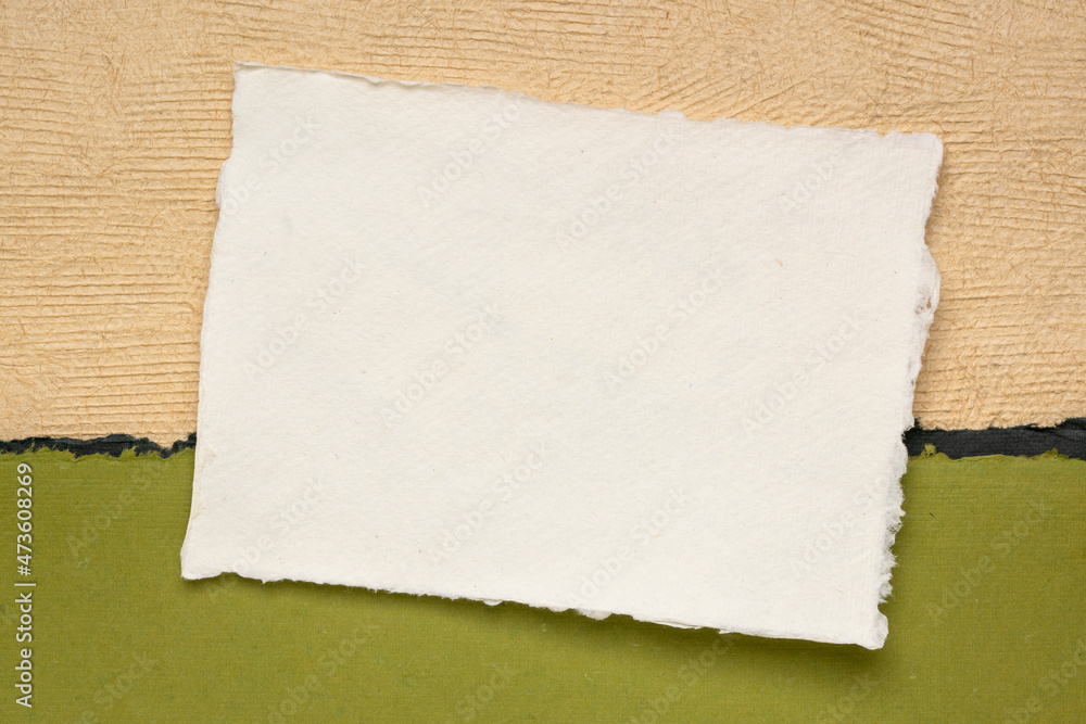 small sheet of blank white Khadi rag paper from South India against abstract landscape