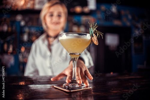 Girl barman creates a cocktail at the porterhouse