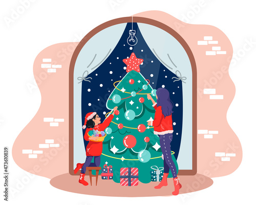 Mom and daughter decorate the Christmas tree together with Christmas balls, garlands and trinkets