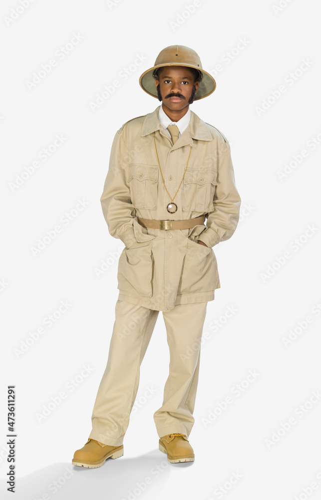 Full length portrait of a boy dressed up as archaeologist mummy hunter for Halloween, against a white background Full length portrait of a boy dressed up as archaeologist mummy hunter for Halloween, against a white background