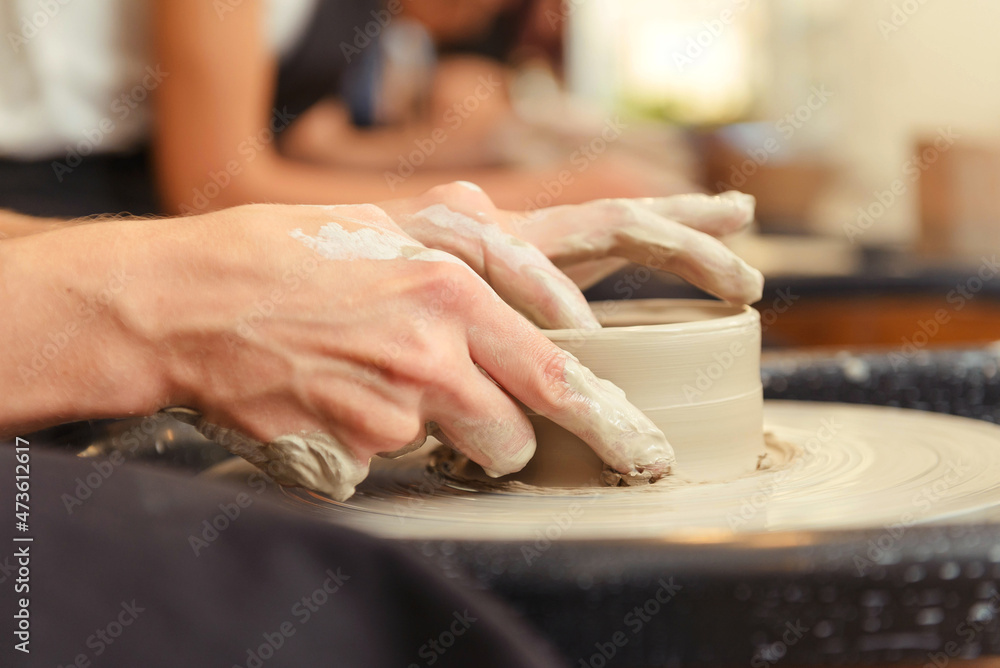 Woman's hands making pottery