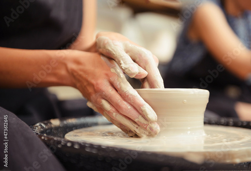 potter, clay, workshop, Woman's hands making pottery circle