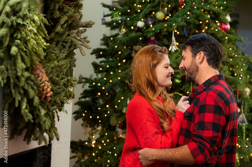 Couple kissing at home during Christmas photo