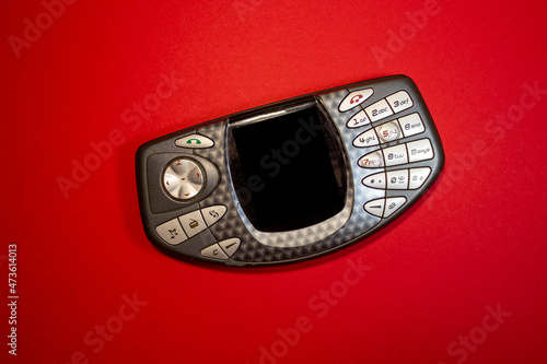 An old gaming phone on a red background
