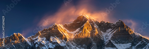 Fotografie, Obraz first sun light and wind in clouds above summits Lhotse and Neptse close to Ever