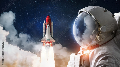 Obraz na plátně Astronaut and Space Shuttle rocket launch in the sky with clouds