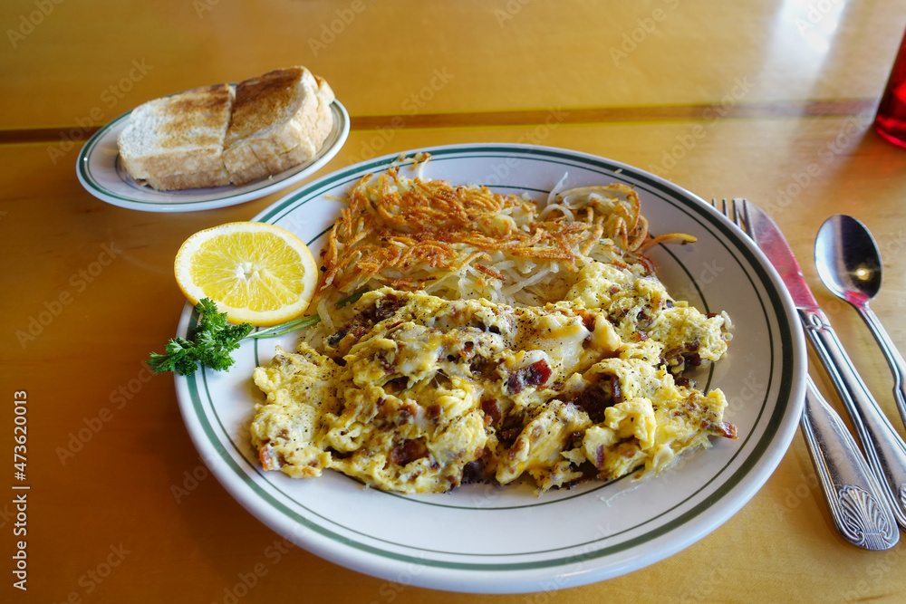 Hearty bacon and egg scramble with hashbrowns and toast Hearty bacon and egg scramble with hashbrowns and toast