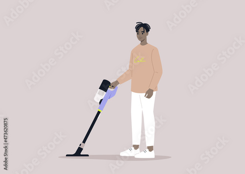 A male African character cleaning with a cordless vacuum cleaner, household chores