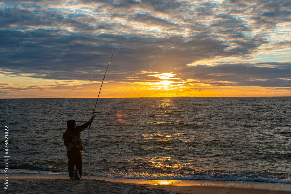 Silhouette of Fisherman at Baltic Sea at Sunset, Estonia