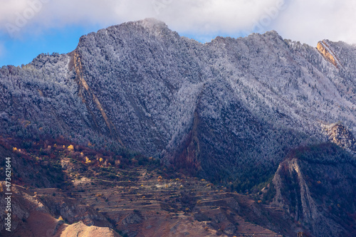 Fantastic high rocks. Autumn landscape with steep mountain peaks. First snow in Caucasus Mountains in Dagestan, Russia. Panoramic view of the Caucasian ridges and sharp rocks