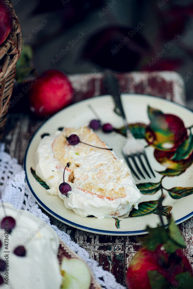 Biscuit roll with apples and whipped cream.Dark rustic photo Biscuit roll with apples and whipped cream.Dark rustic photo