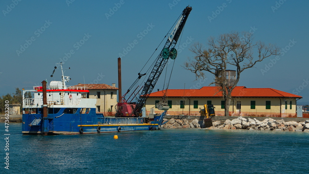 Maintenance of the coast in the lagoon at Grado, Italy, Europe
