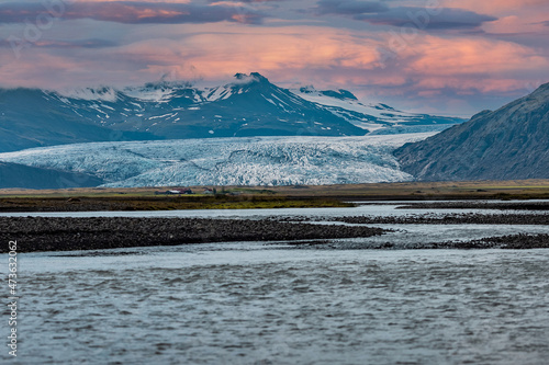 Amazing icelandic glacier at hoffell, visible the tongue approaching the ground and water flowing from below. photo